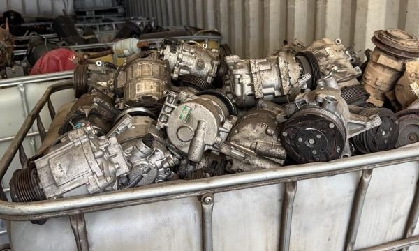 Crate of used catalytic converters and exhaust parts
