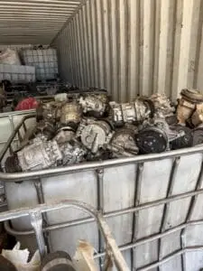 Air conditioning compressors bulk-stored in cages for recycling