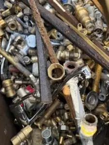 Mixed brass fittings, taps and valves in a scrap bin at SA Copper Scraps