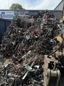 Grab loading a large cable scrap pile at the SA Copper Scraps yard